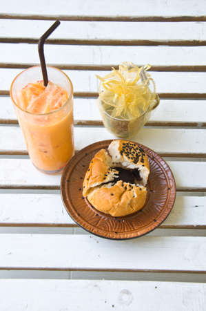 Ice tea and Chocolate bun in coffee shopの写真素材