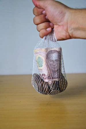 male hand keep Thai moneyの写真素材