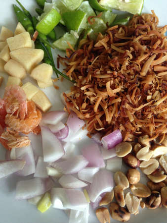 Miang Kham is a tasty snack often sold as Thailand street food  It involves wrapping little tidbits of several items in a leaf, along with a sweet-and-salty sauce  の素材