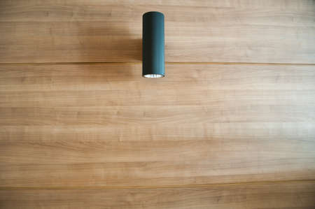 wood wall and black ceiling lampsの写真素材