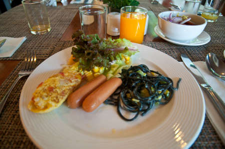 breakfast at a cozy taboe. Set table with a plate full of fresh fruits for a healthy breakfast.の写真素材