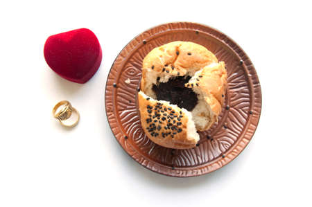 A marriage proposal using a fortune bread and gold ring の写真素材