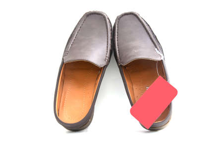 brown slip-on casual shoes over a white backgroundの写真素材