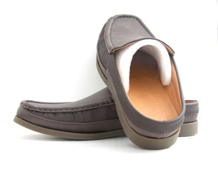 new brown slip-on casual shoes over a white backgroundの写真素材