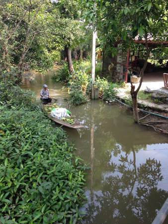Man on Boat in river of countryside at Thailandの素材