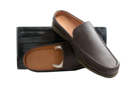 Pair of brown male shoes in front of sale box on whiteの写真素材