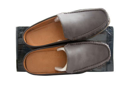 Pair of brown male shoes in front of sale box on whiteの写真素材