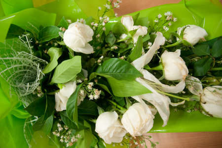 Wedding bouquet of white roses on wooden floorの写真素材
