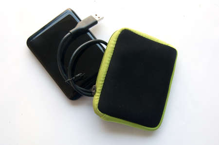 Portable external hard disk drive with USB cable on white backgroundの写真素材