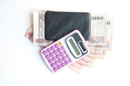 1000 baht banknotes and calculator isolated on white backgroundの写真素材