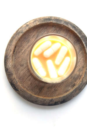 Capsule pill sinking in water close-up