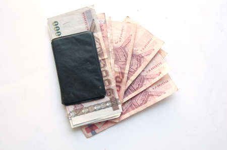 1000 and 100 baht banknotes and calculator isolated on white backgroundの写真素材