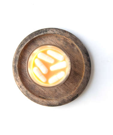 Capsule pill sinking in water close-upの写真素材