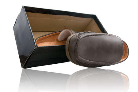Pair of brown male shoes in front of sale box on whiteの写真素材