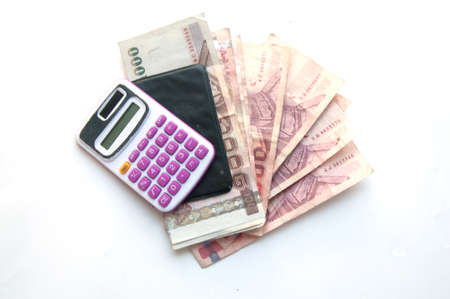 1000 and 100 baht banknotes and calculator isolated on white backgroundの写真素材