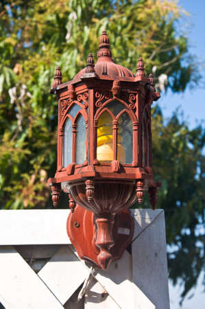 wooden hanging lamp with background of gardenの写真素材