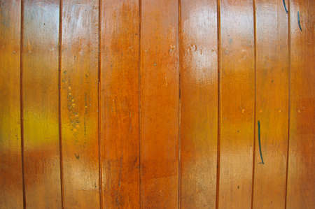 Wooden pine boards lying together in brown color with linesの写真素材