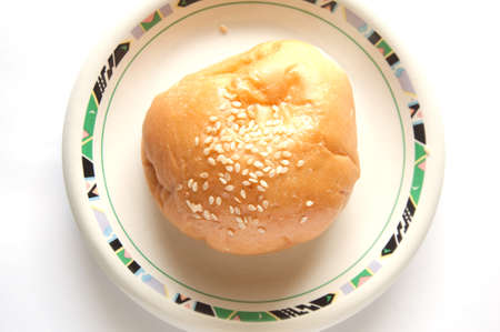 delicious bun with sesame seeds isolated on white