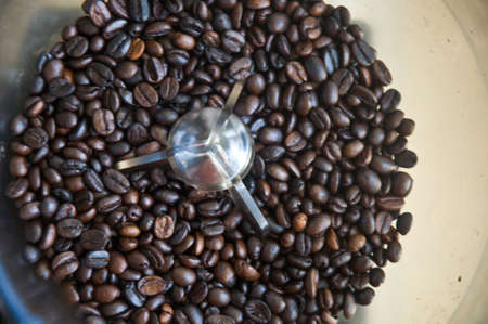 roasted coffee beans in coffee machineの写真素材
