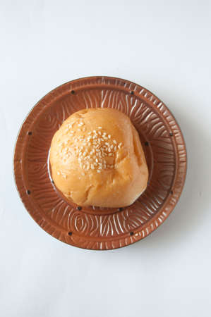 delicious bun with sesame seeds isolated on white