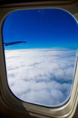 Looking through window aircraft during flight in wing with a nice blue skyの写真素材