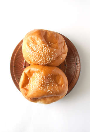 delicious bun with sesame seeds isolated on whiteの写真素材