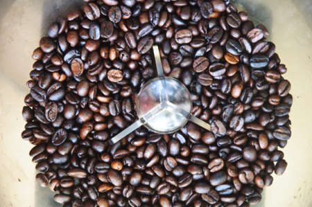 roasted coffee beans in coffee machineの写真素材