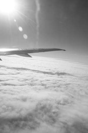 Looking through window aircraft during flight in wing with a nice blue skyの写真素材