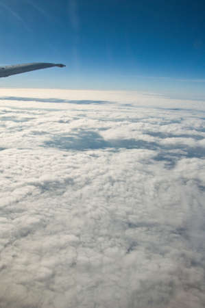 Aerial view of cloudy sky from aircraft windowsの写真素材