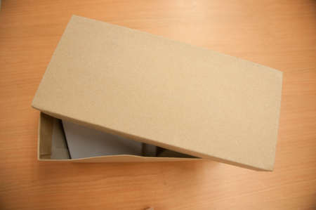 a cardboard box  on wood tablea
