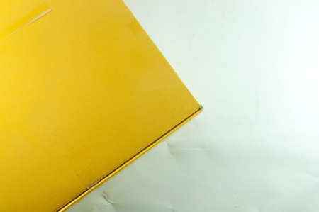 Yellow gift box isolated on whiteの写真素材