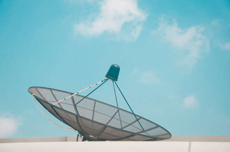 Satellite TV receiver on blue sky with cloud background