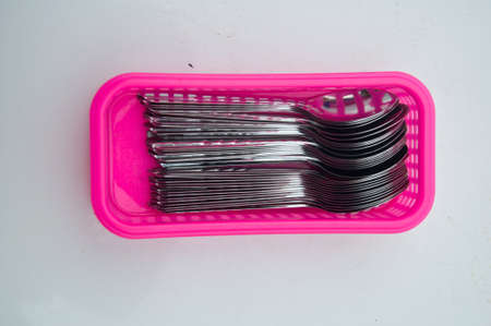 spoons in pink basket