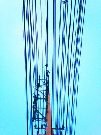 Electric high voltage poles on blue skyの素材