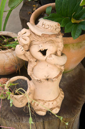 The cute girl figurine terracotta on gardenの写真素材