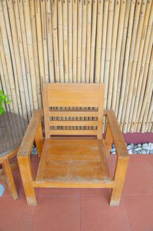wooden armchair with bamboo wallの写真素材