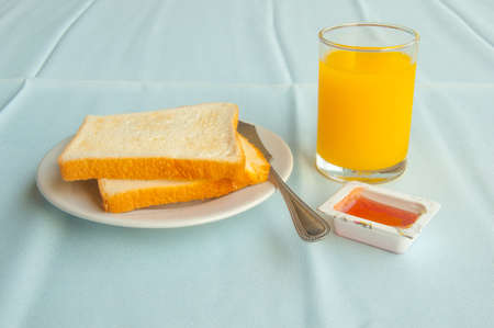 breakfast with toasts, jam and orange juiceの写真素材