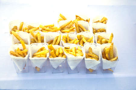 French Fries in small box with sticks as appetizer for the wedding party or business meeting