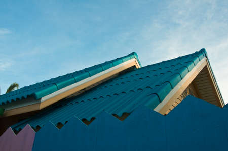 Roof of a new blue wooden house with a blue sky