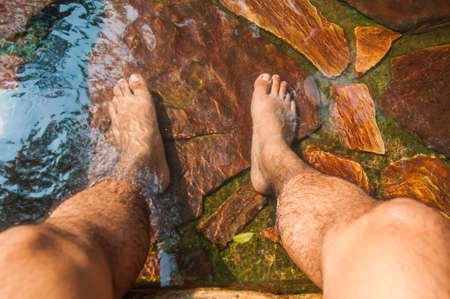 Rest your feet on nature poolの写真素材