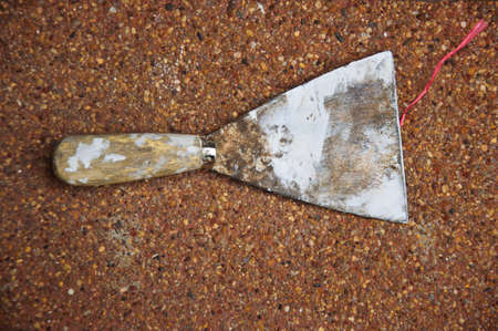 Rusty old used metal shovel and trowel as used for gardening worksの写真素材