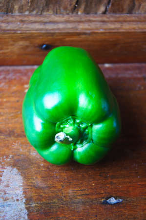 Green pepper on wood background, close upの写真素材