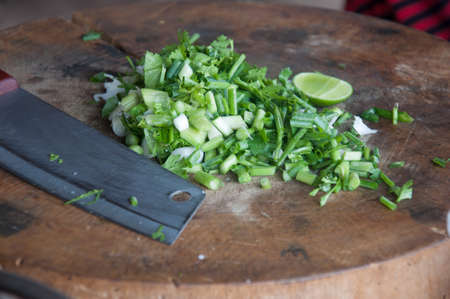 Chopped green onions on a cutting board and knifeの写真素材