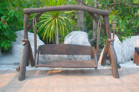 wooden swing in the gardenの写真素材