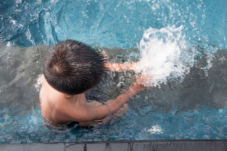Activities on the pool, children swimming and playing in waterの写真素材