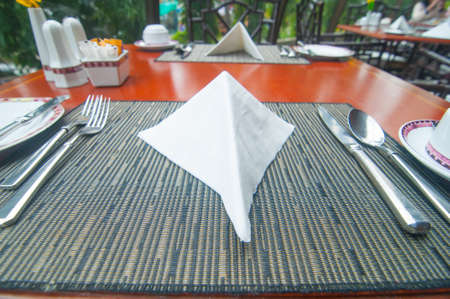 table setting - plate, knife and fork on tableの写真素材