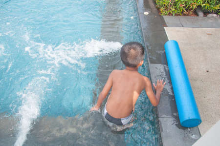 happy boy kid in the poolの写真素材