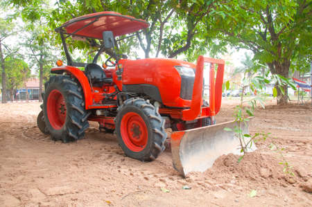 huge tractor collecting haystackの写真素材