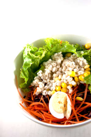 Fresh vegetable salad in bowl isolated on whiteの写真素材