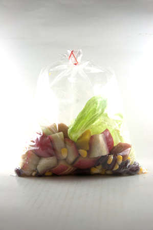 Fresh fruits salad in packing  on whiteの写真素材